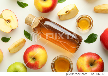 Homemade apple vinegar and ingredients on white background Homemade apple vinegar and ingredients on white background 84806168