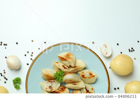 Concept of tasty food with vareniki or pierogi on white background Concept of tasty food with vareniki or pierogi on white background 84806211