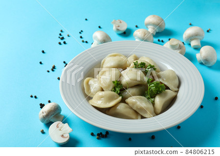 Concept of tasty food with vareniki or pierogi on blue background 84806215