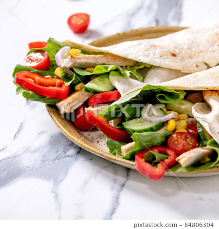 Traditional mexican tortila wrap with pork meat Traditional mexican tortila wrap with pork meat 84806304