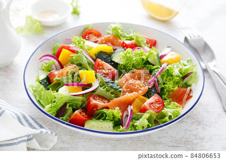 Salted salmon salad with fresh green lettuce, cucumbers, tomato, bell pepper and red onion. Ketogenic, keto or paleo diet lunch bowl Salted salmon salad with fresh green lettuce, cucumbers, tomato, bell pepper and red onion. Ketogenic, keto or paleo diet lunch bowl 84806653