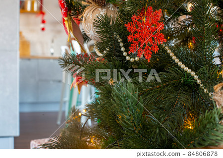 cozy decorated christmas tree with red colored decor in hone interior close up cozy decorated christmas tree with red colored decor in hone interior close up 84806878