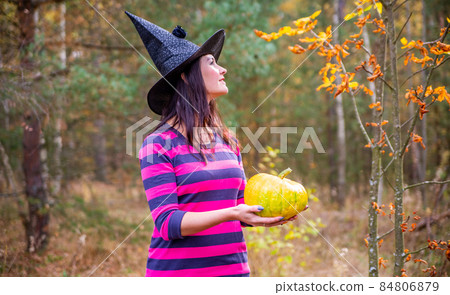 Young witch in the autumn forest Young witch in the autumn forest 84806879