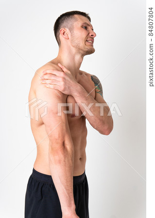 A sore shoulder joint muscle in a white man on a white background sore painful, sick isolated young adult, holding. neck therapy, ain suffer attractive A sore shoulder joint muscle in a white man on a white background sore painful, sick isolated young adult, holding. neck therapy, ain suffer attractive 84807804