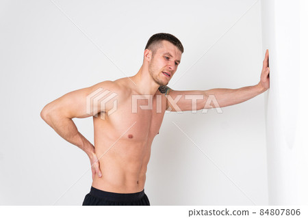 A man back pain keeps his hand on his back back hurt painful, backache male massage stress, muscular expression. Touching red disease suffer attractive A man back pain keeps his hand on his back back hurt painful, backache male massage stress, muscular expression. Touching red disease suffer attractive 84807806