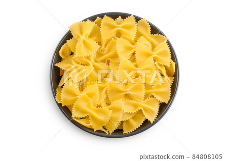 Bow tie pasta in the bowl isolated on white background with clipping path and full depth of field. Top view. Flat lay. 84808105