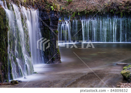 Water flow like thin white thread of Shiraito Falls, long exposure Water flow like thin white thread of Shiraito Falls, long exposure 84809832