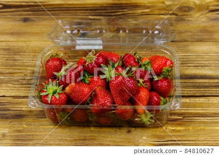 Fresh strawberry in plastic box on a wooden table 84810627