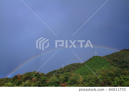 Rainbow, a rainbow over the mountain ridge in autumn Rainbow, a rainbow over the mountain ridge in autumn 84811735