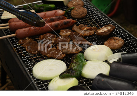 Genghis Khan barbecue over charcoal in a garden in Hokkaido Genghis Khan barbecue over charcoal in a garden in Hokkaido 84812346