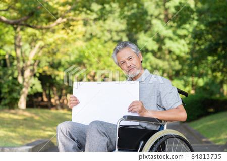 Think of a senior man in a wheelchair with a whiteboard Think of a senior man in a wheelchair with a whiteboard 84813735