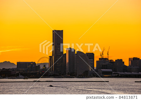 Magic hour Minato Mirai and Mt. Fuji, illuminated Yokohama port and Mt. Fuji dyed in the setting sun, Yokohama sunset Magic hour Minato Mirai and Mt. Fuji, illuminated Yokohama port and Mt. Fuji dyed in the setting sun, Yokohama sunset 84813871