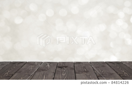 Brown wooden table and white bokeh for festivebackground Brown wooden table and white bokeh for festivebackground 84814226
