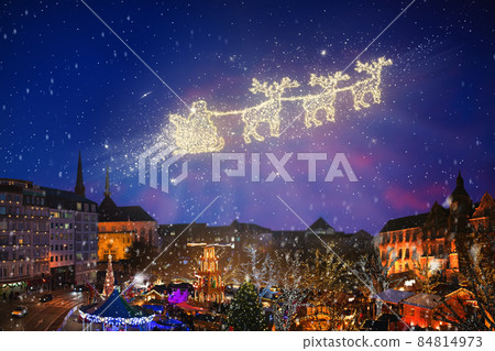 Santa in sled flying over Christmas night city. 84814973