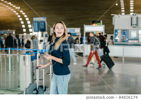 Caucasian female person chatting by smarphone at airport hall. Caucasian female person chatting by smarphone at airport hall. 84816174