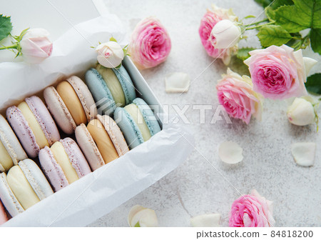 Colorful macaroons in a gift box and roses Colorful macaroons in a gift box and roses 84818200