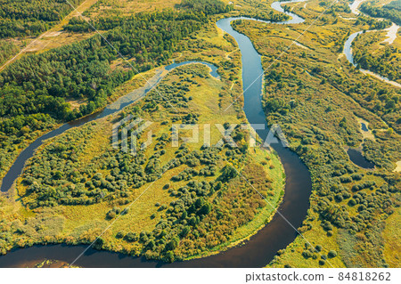 Aerial View Green Forest Woods And River Landscape In Sunny Spring Summer Day. Top View Of Beautiful European Nature From High Attitude In Autumn Season. Drone View. Bird's Eye View 84818262