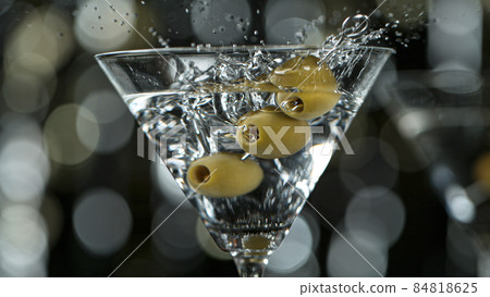 Falling olives into martini drink Falling olives into martini drink 84818625