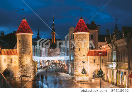 Tallinn, Estonia. Famous Landmark Viru Gate In Street Lighting At Evening Or Night Illumination. Towers In Christmas Holidays Decorations Tallinn, Estonia. Famous Landmark Viru Gate In Street Lighting At Evening Or Night Illumination. Towers In Christmas Holidays Decorations 84818692
