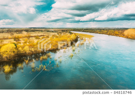River During Spring Flood Water. Aerial View Landscape. Top View Of Beautiful European Nature From High Attitude In Springtime Season River During Spring Flood Water. Aerial View Landscape. Top View Of Beautiful European Nature From High Attitude In Springtime Season 84818746