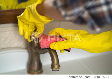 Girl in rubber gloves is cleaning bathroom. Girl in rubber gloves is cleaning bathroom. 84819225
