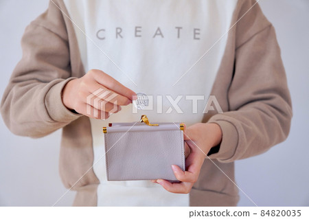 A child taking money out of his wallet A child taking money out of his wallet 84820035