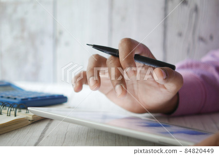 analyzing stock market data on digital tablet analyzing stock market data on digital tablet 84820449