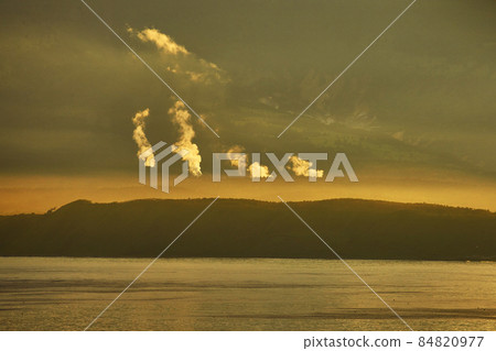 Amazing sunset with fumarole smoke from volcano Mendeleev (Rausu-dake in Japanese). Kunashir island 84820977