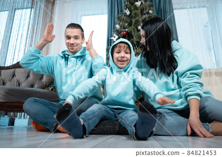 happy family with mother father and son have fun on christmas decorating tree 84821453