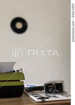 Vintage old film camera and typewriter at wooden desk table Vintage old film camera and typewriter at wooden desk table 84821664