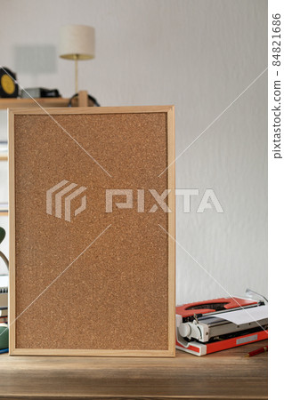 Cork board frame background and vintage typewriter on table in office Cork board frame background and vintage typewriter on table in office 84821686
