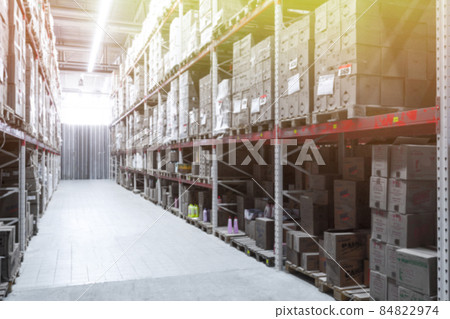 interior of a logistics center with boxes and large racks, blurred photography, defocus 84822974