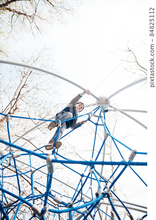 beautiful little boy playing in a rope maze beautiful little boy playing in a rope maze 84825112