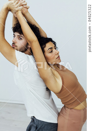 Man and woman together doing exercises family yoga asana fitness 84825322