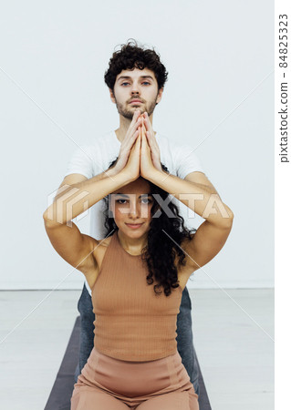 Man and woman together doing exercises family yoga asana fitness Man and woman together doing exercises family yoga asana fitness 84825323