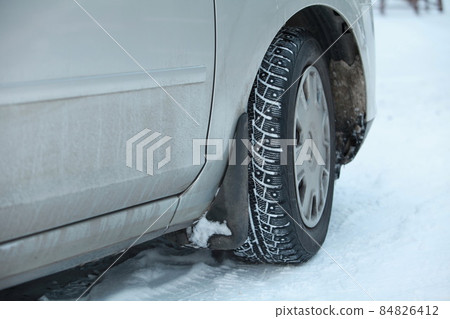 car wheel with winter studded tires 84826412
