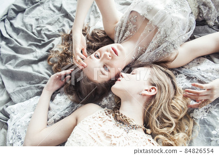 two pretty twin sister blond curly hairstyle girl in luxury house interior together, rich young people concept two pretty twin sister blond curly hairstyle girl in luxury house interior together, rich young people concept 84826554