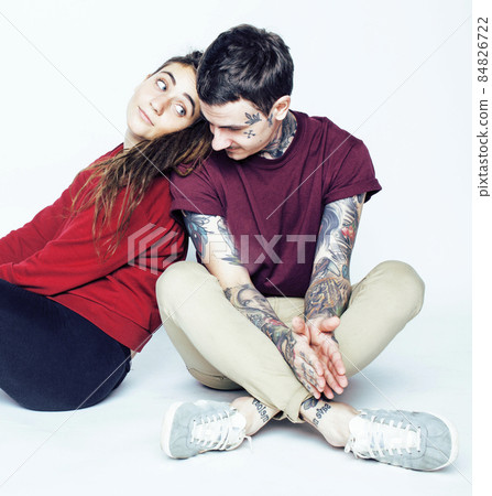Young couple together. guy with tattoo, girlfriend wearing dreadlocks having fun on white background 84826722