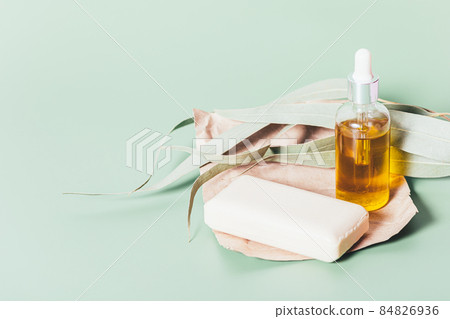 Cosmetic oil bottle and soap bar on craft paper Cosmetic oil bottle and soap bar on craft paper 84826936