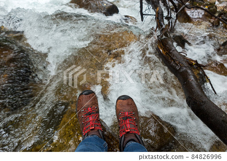 Women's feet in trekking boots Women's feet in trekking boots 84826996