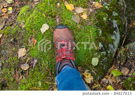 Woman's foot in trekking boots 84827015