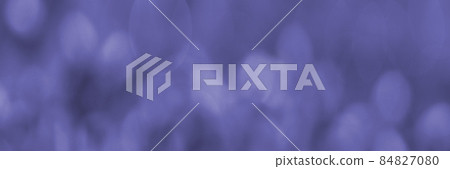 Purple Banner with blurred twinkling lights on a background. For use in the background. soft focus shooting in monochrome color. Copy space. The fashionable color of 2022. Very peri color background. 84827080