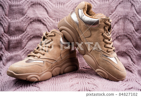 beige sport shoes on knitted background, sport fashion 84827102