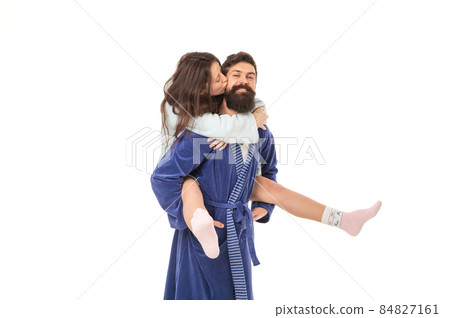 Romantic girl kissing and hugging happy man giving her piggyback ride in morning, romance 84827161