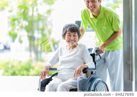Senior female in a wheelchair and a caregiver Photographing cooperation: Japanese Language School attached to Central Technical School Senior female in a wheelchair and a caregiver Photographing cooperation: Japanese Language School attached to Central Technical School 84827699