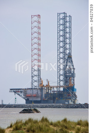 On shore oil rig metal structure across sea in Great Yarmouth  84827839