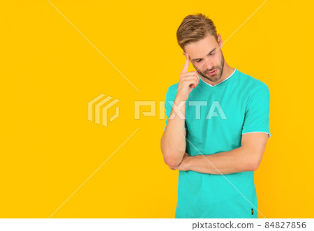 pondering man in red shirt on yellow background with copy space, casual pondering man in red shirt on yellow background with copy space, casual 84827856