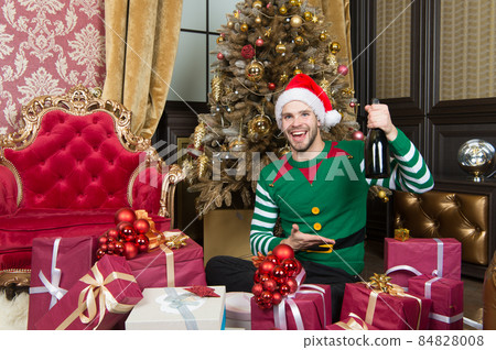 Merry Christmas and Happy New Year. Man in santa hat Merry Christmas and Happy New Year. Man in santa hat 84828008