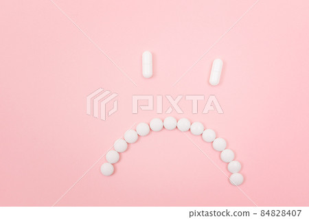 Pharma Harm. Sad Smiley Face Made from White Pills 84828407