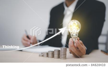 thinking and creative concept, Close up light bulb and working on the desk, Creativity and innovation are keys to success.Concept of new idea and innovation with Brain and light bulbs, working at home 84828410